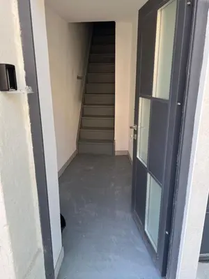 an empty hallway with stairs in a building at Appartement douzens in Douzens