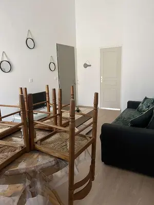 a living room with a table and a couch at Appartement douzens in Douzens