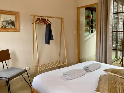 a bedroom with a bed with two towels on it at L'Escale médiévale in Carcassonne