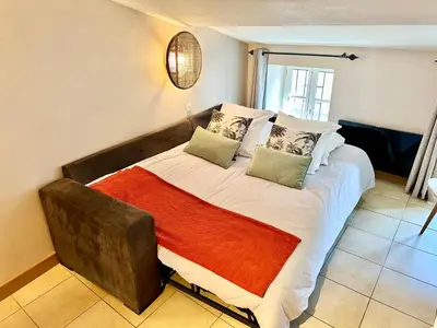 a bedroom with a large bed with pillows on it at L'Escale médiévale in Carcassonne