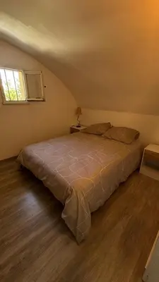 a bedroom with a large bed in a room at Location maison vacances T3 in Gruissan