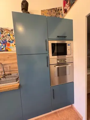 a kitchen with a refrigerator and a microwave at Gîte de Mia in Ventenac en Minervois