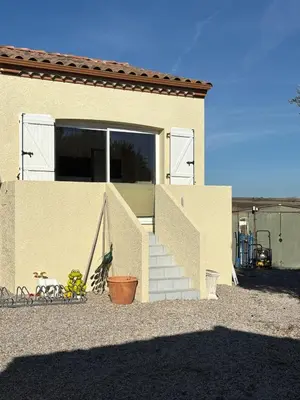a building with a staircase and a door and a building at Gîte de Mia in Ventenac en Minervois