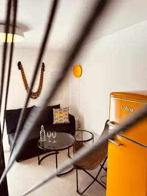 a living room with a table and a couch at La Nine in Aigne