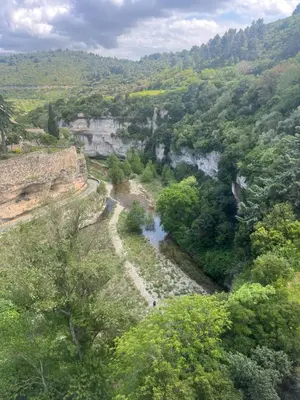 an aerial view of a river in a valley at La Nine in Aigne