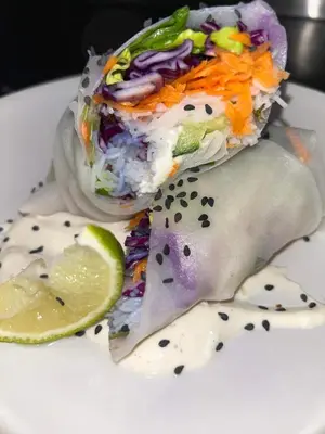 a plate of food with a wrap and a lime at La Nine in Aigne