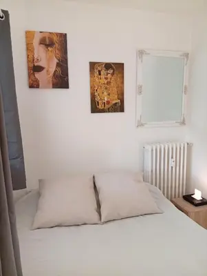 a bedroom with three pictures on the wall and a bed at Mistral gagnant ! T1 calme avec vue, parking, télétravail, Wi-Fi, proche CV et gare in Mazamet