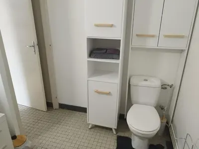 a bathroom with a toilet and white cabinets at Mistral gagnant ! T1 calme avec vue, parking, télétravail, Wi-Fi, proche CV et gare in Mazamet