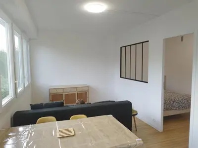 a living room with a couch and a table at Mistral gagnant ! T1 calme avec vue, parking, télétravail, Wi-Fi, proche CV et gare in Mazamet