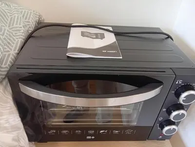 a toaster oven sitting on top of a microwave at Mistral gagnant ! T1 calme avec vue, parking, télétravail, Wi-Fi, proche CV et gare in Mazamet