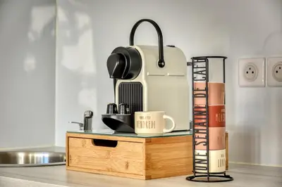 a table with a coffee maker and books on it at Appartement rez-de-chaussée Plage du Grazel in Gruissan