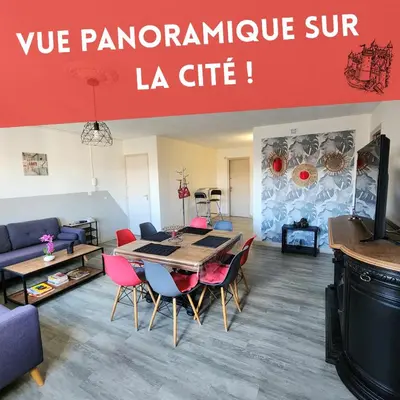 a living room with a table and chairs at Grand appartement vue sur la Cité ! in Carcassonne