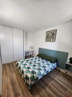 a bedroom with a bed in the middle of a room at Grand appartement vue sur la Cité ! in Carcassonne