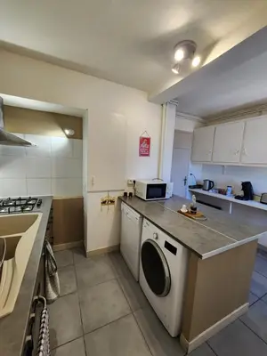 a kitchen with a washer and dryer in it at Grand appartement vue sur la Cité ! in Carcassonne