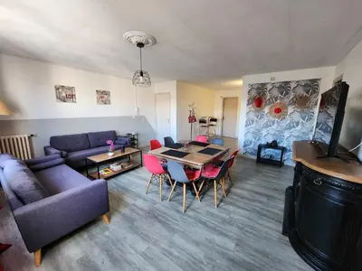 a living room with a couch and a table and chairs at Grand appartement vue sur la Cité ! in Carcassonne