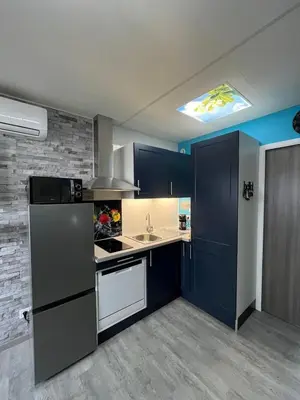 a kitchen with a refrigerator and a sink at Gruissan Plage Studio RDC avec Piscine Wifi Parking Clim in Gruissan