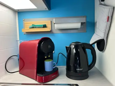 a coffee maker and a toaster on a counter at Gruissan Plage Studio RDC avec Piscine Wifi Parking Clim in Gruissan