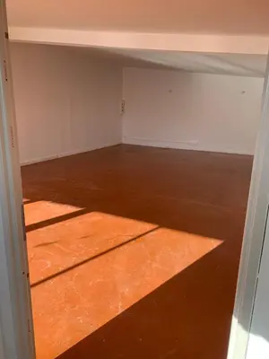 an empty room with a concrete floor and an open door at Local, Training room, seminars, meetings, courses, formation in Castelnaudary