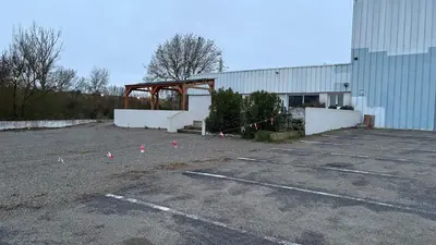 a parking lot with pink cones in front of a building at Local, Training room, seminars, meetings, courses, formation in Castelnaudary