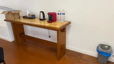 a wooden table in a corner of a room at Local, Training room, seminars, meetings, courses, formation in Castelnaudary
