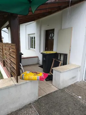 a umbrella laying on the ground outside of a house at Le coin de france in LʼAiguillon