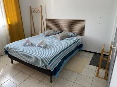 a bed with two stuffed animals on top of it at Chez Eugénia & Frédéric in Port-la-Nouvelle