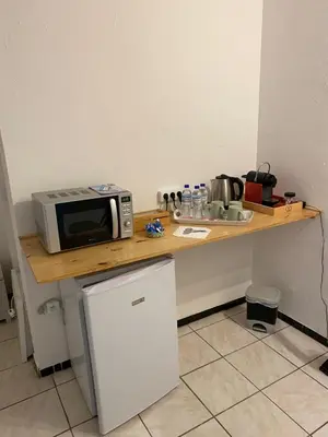 a microwave sitting on top of a counter in a kitchen at Chez Eugénia & Frédéric in Port-la-Nouvelle