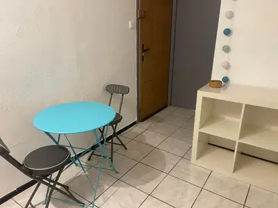 a blue table and two chairs in a room at Chez Eugénia & Frédéric in Port-la-Nouvelle