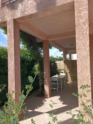 a patio with a table and chairs on it at le studio du Chat qui Pêche in Gruissan