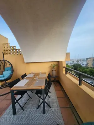a table and chairs on a balcony with a view at Le Roof Top du Port, Nouveau, Bbq Duplex Clim Parking in Gruissan