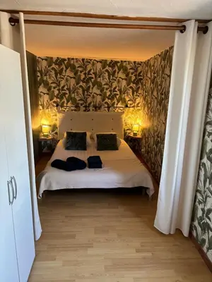 a bedroom with a large bed with two pillows at la saline in Peyriac-de-Mer