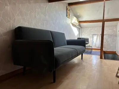 a blue couch in a living room with a room at la saline in Peyriac-de-Mer