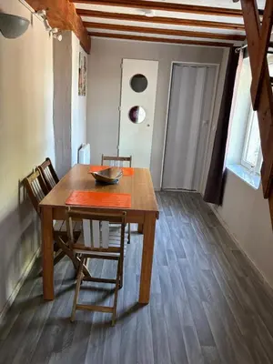 a wooden table and chairs in a room at la saline in Peyriac-de-Mer