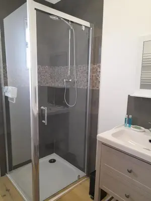 a shower with a glass door in a bathroom at Le Patio in Castelnaudary