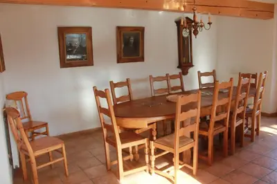 a dining room with a wooden table and chairs at Gite rural de Bergnes à l'ombre des grands pins in Campagne-sur-Aude