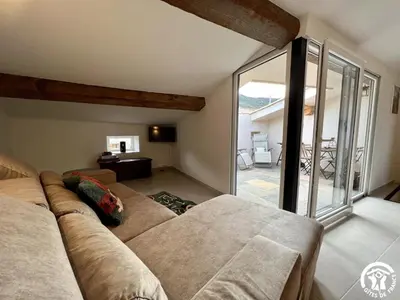a living room with a couch and a large window at Helena in Quintillan