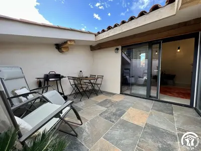 a patio with chairs and a table on a house at Helena in Quintillan