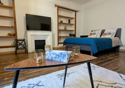 a living room with a table and a couch at Studio cosy et spacieux in Carcassonne