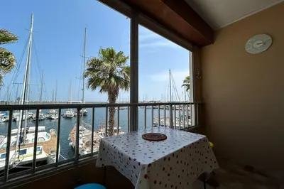a table in a room with a view of a marina at Charming studio with sea view Gruissan in Gruissan
