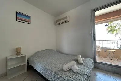 a bedroom with a bed with two towels on it at Charming studio with sea view Gruissan in Gruissan