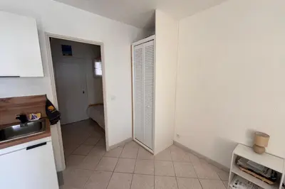 a kitchen with a sink and a door to a room at Charming studio with sea view Gruissan in Gruissan