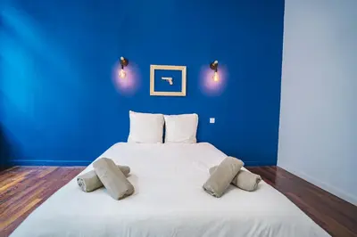 a blue bedroom with a white bed with two pillows at Luxueux-Climatisation-3 chambres-2SDB-Garage -AJ in Carcassonne