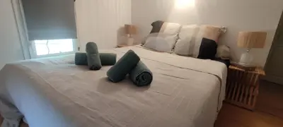 a bedroom with a bed with two pillows on it at AppartZen proche Cité de Carcassonne et lac de la Cavayère in Trèbes