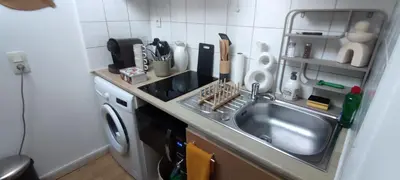 a kitchen with a sink and a washing machine at AppartZen proche Cité de Carcassonne et lac de la Cavayère in Trèbes