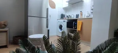 a kitchen with a refrigerator and a washing machine at AppartZen proche Cité de Carcassonne et lac de la Cavayère in Trèbes