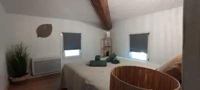a bedroom with a bed with a teddy bear on it at AppartZen proche Cité de Carcassonne et lac de la Cavayère in Trèbes