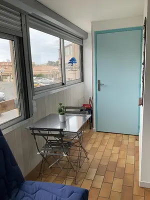 a room with a table and a glass door at Bleu Riviera Lumière, Calme et Air Marin in Port-la-Nouvelle