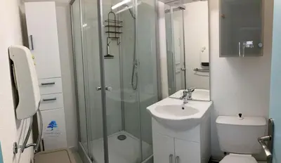 a bathroom with a shower and a toilet and a sink at Bleu Riviera Lumière, Calme et Air Marin in Port-la-Nouvelle
