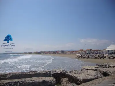 a view of a beach with rocks and the ocean at Bleu Riviera Lumière, Calme et Air Marin in Port-la-Nouvelle
