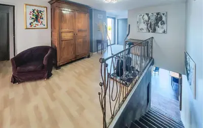 a living room with a staircase and a chair at Cozy Home In La Redorte in La Redorte